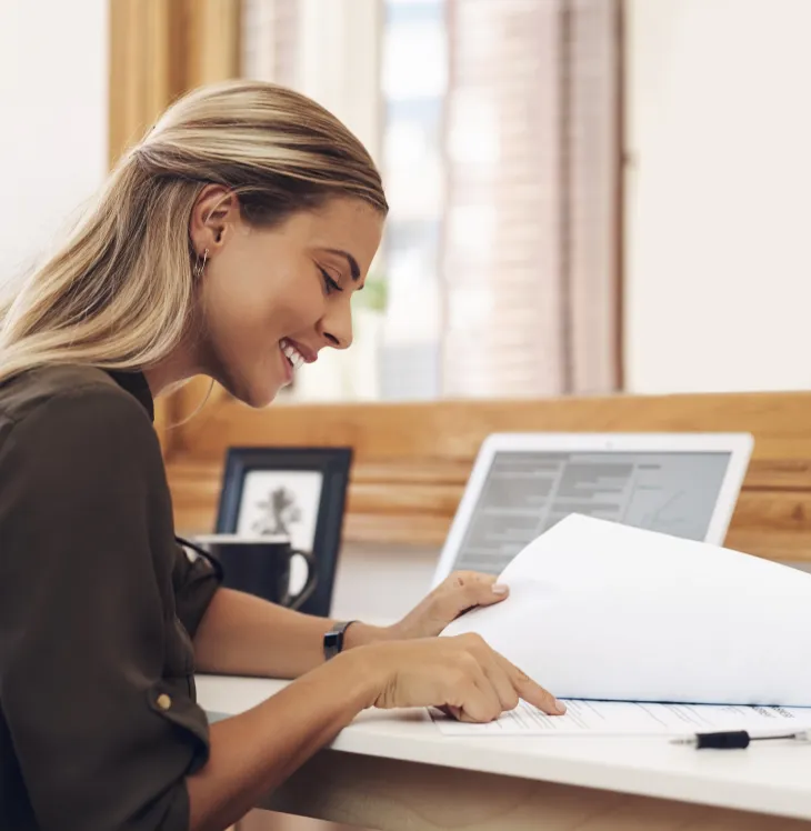 A patient reviewing her dental insurance paperwork at a desk