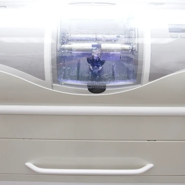 A milling machine shaping a ceramic restoration